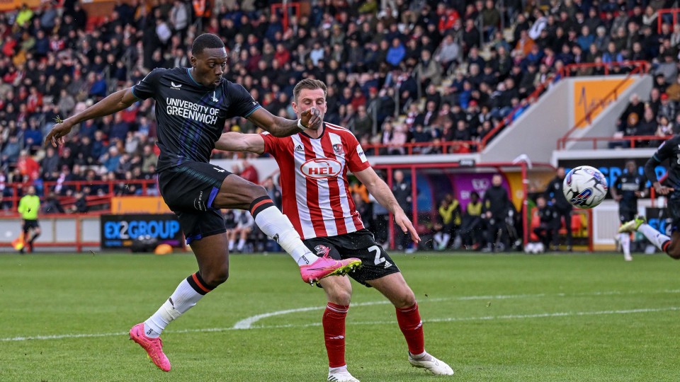 Freddie Ladapo battles Ben Purrington for the ball