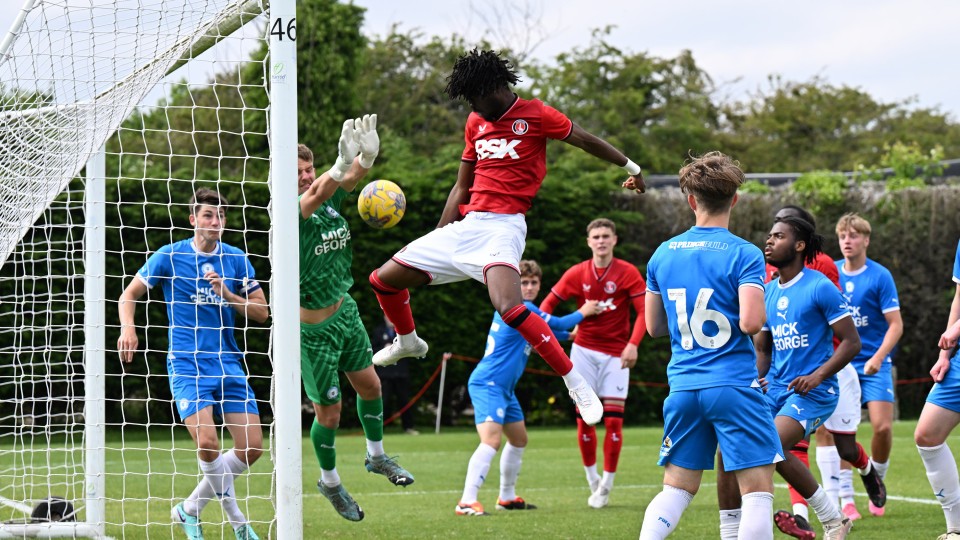 Tolu Ladapo jumps with Jake West as the ball goes into the net.
