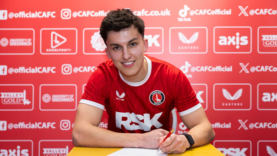 Tom McIntyre signing a contract