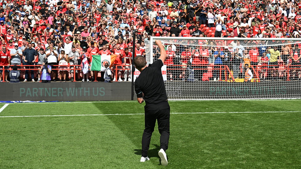 Nathan Jones celebrates in front of the Covered End