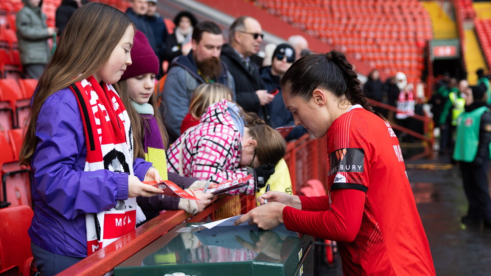 Katie Bradley signs stuff for fans