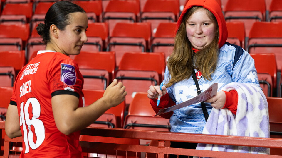 Gloria Siber signing something for a fan
