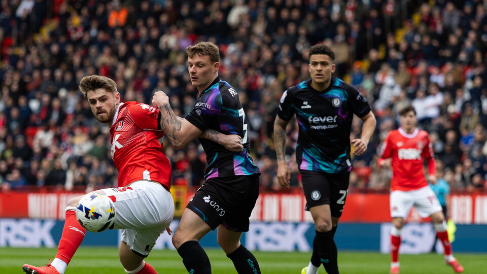 Charlie Kelman challenges for the ball