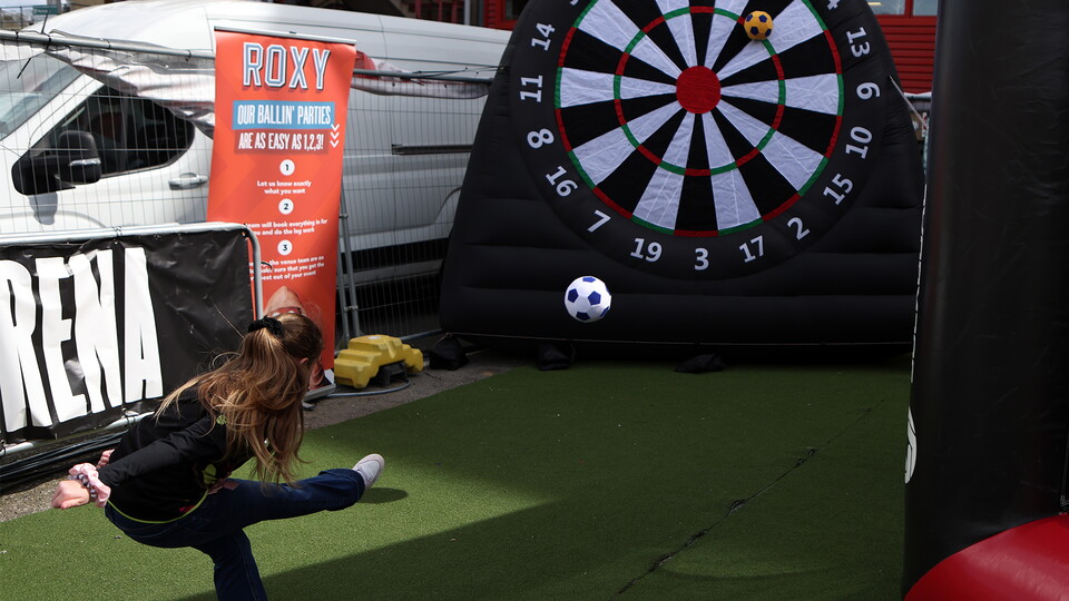Fan in Fan Zone kicking a ball