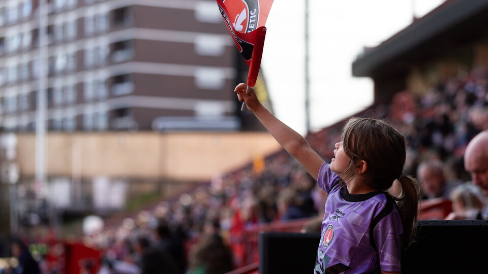 Fan waves flag at Charlton game